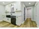 Charming kitchen featuring white cabinets, subway tile backsplash, and modern black appliances at 3421 Fawn Trl, Marietta, GA 30066