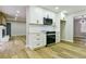 Spacious kitchen with stainless steel appliances, white cabinets, and hardwood floors at 3421 Fawn Trl, Marietta, GA 30066