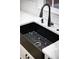 Close up of the kitchen's black sink, faucet, and white countertop at 3421 Fawn Trl, Marietta, GA 30066