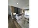 Modern living room with statement wall, neutral furniture, and hardwood floors at 3421 Fawn Trl, Marietta, GA 30066