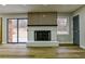 Bright living room featuring a modern fireplace, sliding glass doors, and wood-look flooring at 3421 Fawn Trl, Marietta, GA 30066