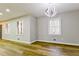 Bright living room with hardwood floors, modern light fixture, and double-hung windows at 3421 Fawn Trl, Marietta, GA 30066