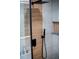Close-up of a modern shower featuring sleek black fixtures and unique wood-look paneling at 3421 Fawn Trl, Marietta, GA 30066