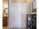 Small bathroom with shower and shelf storage at 4248 Hog Mountain Rd, Hoschton, GA 30548