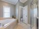 Bathroom with soaking tub, shower, and toilet at 4248 Hog Mountain Rd, Hoschton, GA 30548