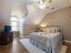 Bright bedroom featuring a queen-size bed and a large window with window coverings at 4248 Hog Mountain Rd, Hoschton, GA 30548