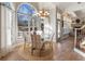 Bright dining room with glass table and hardwood floors at 4248 Hog Mountain Rd, Hoschton, GA 30548