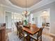 Elegant dining room with a large table and access to the kitchen at 4248 Hog Mountain Rd, Hoschton, GA 30548