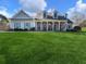 Two-story house with gray siding, brick accents, and a covered porch at 4248 Hog Mountain Rd, Hoschton, GA 30548