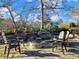 Stone fire pit surrounded by Adirondack chairs in backyard at 4248 Hog Mountain Rd, Hoschton, GA 30548