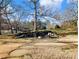 Landscaped backyard with a stone fire pit and seating area at 4248 Hog Mountain Rd, Hoschton, GA 30548