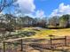 Serene pasture with wooden fence and gate, offering ample space at 4248 Hog Mountain Rd, Hoschton, GA 30548