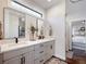 Double vanity bathroom with modern finishes and a view to the bedroom at 4258 Hog Mountain Rd, Hoschton, GA 30548
