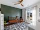 Bedroom with a green accent wall and plenty of space for play at 4258 Hog Mountain Rd, Hoschton, GA 30548