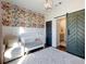 Bedroom with crib, armchair, and barn door leading to the bathroom at 4258 Hog Mountain Rd, Hoschton, GA 30548