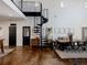 Modern farmhouse dining room with spiral staircase and stained concrete floors at 4258 Hog Mountain Rd, Hoschton, GA 30548