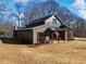 Modern farmhouse exterior with covered porch and large windows at 4258 Hog Mountain Rd, Hoschton, GA 30548