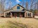 Farmhouse style home with covered porch and American flag at 4258 Hog Mountain Rd, Hoschton, GA 30548