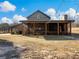 A charming barn-style home with a large screened porch and expansive backyard at 4258 Hog Mountain Rd, Hoschton, GA 30548
