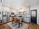 Spacious kitchen with an island, stainless steel appliances, and a farmhouse style at 4258 Hog Mountain Rd, Hoschton, GA 30548