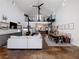 Open concept living space with loft, fireplace, and stained concrete floors at 4258 Hog Mountain Rd, Hoschton, GA 30548