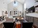 Spacious living room with vaulted ceiling, large sectional sofa, and built-in shelving at 4258 Hog Mountain Rd, Hoschton, GA 30548