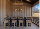 Rustic outdoor bar with wooden countertop and rustic stools at 4258 Hog Mountain Rd, Hoschton, GA 30548