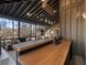 Long wooden bar top with metal base on a screened porch at 4258 Hog Mountain Rd, Hoschton, GA 30548