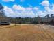 Large, grassy pasture with distant views and mature trees at 4258 Hog Mountain Rd, Hoschton, GA 30548