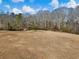 Open pasture with a small shed and tree line in the background at 4258 Hog Mountain Rd, Hoschton, GA 30548