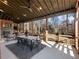 Large screened porch with dining area, fireplace, and wooded views at 4258 Hog Mountain Rd, Hoschton, GA 30548