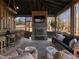 Spacious screened porch with fireplace, bar, and comfortable seating at 4258 Hog Mountain Rd, Hoschton, GA 30548