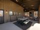 Screened porch with wood walls, dining table, and view of woods at 4258 Hog Mountain Rd, Hoschton, GA 30548