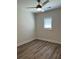 Bright bedroom with ceiling fan and wood-look floors at 6521 Brown St, Douglasville, GA 30134