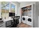 Convenient laundry area with washer, dryer, and built-in shelving at 22 Airline Ne St # 106, Atlanta, GA 30312