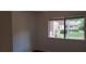 Bright bedroom with a window and dark brown flooring at 33 Country Place Ct, Alpharetta, GA 30005
