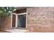 Brick exterior with sliding glass door leading to a small patio at 33 Country Place Ct, Alpharetta, GA 30005