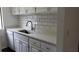 Clean kitchen featuring white cabinets, a quartz countertop, and stainless steel sink at 33 Country Place Ct, Alpharetta, GA 30005