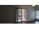 Living room with dark hardwood floors and sliding glass door to patio at 33 Country Place Ct, Alpharetta, GA 30005