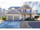 Two-story house with gray siding, two-car garage, and landscaped yard at 4905 Clearstone Nw Way, Acworth, GA 30101