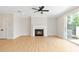 Living room with fireplace and sliding glass doors leading to the backyard at 202 Grady Burrell Dr, Holly Springs, GA 30115