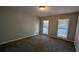 Spacious bedroom with neutral walls and carpet flooring at 227 Camp Creek Sw Rd, Lilburn, GA 30047