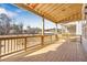 Covered back porch with wooden deck and backyard views at 152 Palm St, Holly Springs, GA 30115