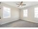 Bright bedroom with two windows and ceiling fan at 152 Palm St, Holly Springs, GA 30115