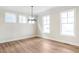 Spacious dining room with hardwood floors and chandelier at 152 Palm St, Holly Springs, GA 30115