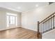 Bright foyer with hardwood floors and staircase at 152 Palm St, Holly Springs, GA 30115