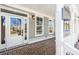 Front porch with brick flooring and white columns at 152 Palm St, Holly Springs, GA 30115