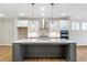 Large kitchen island with quartz countertop and gray cabinets at 152 Palm St, Holly Springs, GA 30115