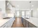 Modern kitchen features white cabinets, quartz countertops, and stainless steel appliances at 152 Palm St, Holly Springs, GA 30115