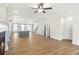 Open concept living space with hardwood floors, fireplace and views into the kitchen at 152 Palm St, Holly Springs, GA 30115